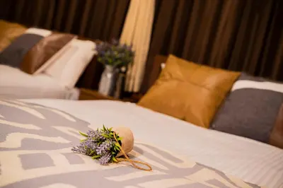 a bunch of flowers sitting on top of a bed at Shinjuku Homely Stay in Tokyo