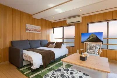 a hotel room with a bed and a couch at Mi-APT Nakaitabashi Near Ikebukuro in Tokyo