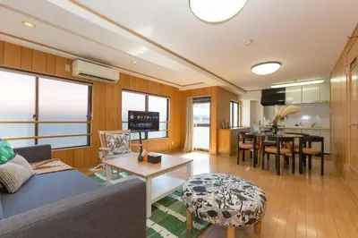 a living room with a couch and a table at Mi-APT Nakaitabashi Near Ikebukuro in Tokyo