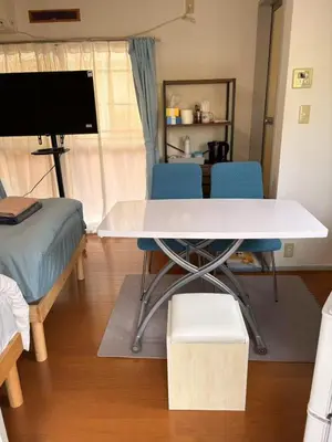 a room with a table and two chairs and a bed at JapanHouse Takadanobaba #Shinjuku Area in Tokyo
