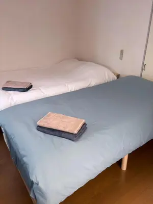 two beds with towels sitting on top of them at JapanHouse Takadanobaba #Shinjuku Area in Tokyo
