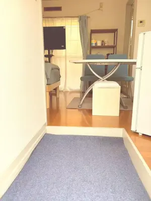 a living room with a table and a blue rug at JapanHouse Takadanobaba #Shinjuku Area in Tokyo