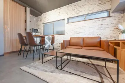 a living room with a couch and a table at Guest Residence Kanamecho in Tokyo