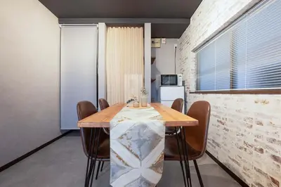 a dining room with a table and chairs at Guest Residence Kanamecho in Tokyo