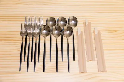 a group of forks and spoons on a wooden table at Guest Residence Kanamecho in Tokyo