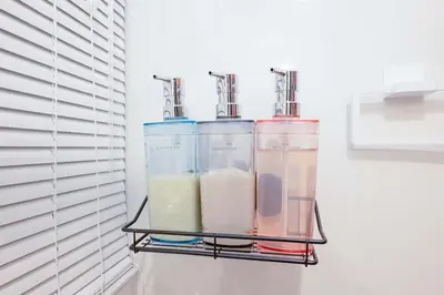 a shelf with three containers of liquid at Guest Residence Kanamecho in Tokyo