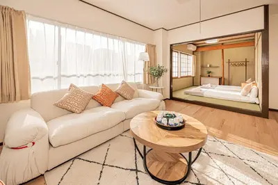 a living room with a white couch and a table at Mori hotel \u5341\u6761401 in Tokyo