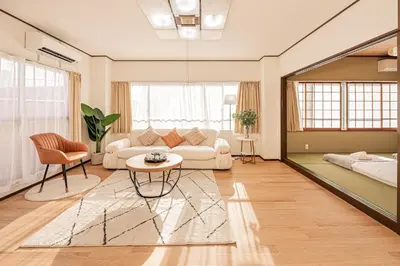 a living room with a couch and a table at Mori hotel \u5341\u6761401 in Tokyo