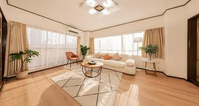 a living room with a couch and a table at Mori hotel \u5341\u6761401 in Tokyo