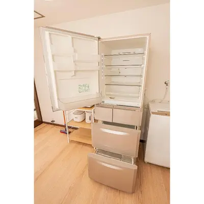 an empty refrigerator with its door open in a room at Mori hotel \u5341\u6761401 in Tokyo