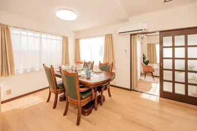 a dining room with a wooden table and chairs at Mori hotel \u5341\u6761401 in Tokyo