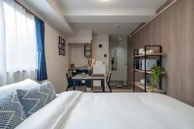 a bedroom with a bed and a dining room at CraftFlat Numabukuro 305, uphill residence monthly stay in Tokyo