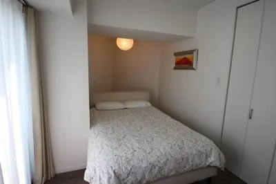 a small bedroom with a bed and a window at arpeggioTERRACE 701 in Tokyo