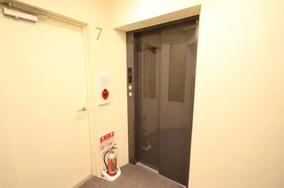 a bathroom with a black door and a fire extinguisher at arpeggioTERRACE 701 in Tokyo
