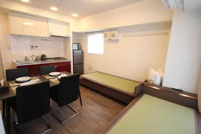 a small kitchen with a table and a bed in it at arpeggioTERRACE 701 in Tokyo