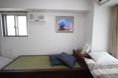 a small bedroom with a bed and a window at arpeggioTERRACE 701 in Tokyo