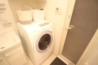 a washing machine in a bathroom next to a sink at arpeggioTERRACE 701 in Tokyo