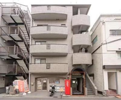 a tall building with stairs on the side of it at My Sumida Home A in Tokyo