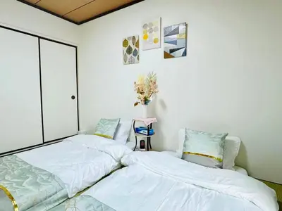 two beds sitting next to each other in a bedroom at Ikebukuro\u4e2d\u5ddd6H-TS0037 in Tokyo