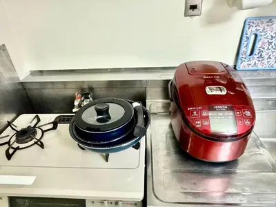 a red toaster sitting on top of a stove at Ikebukuro\u4e2d\u5ddd6H-TS0037 in Tokyo