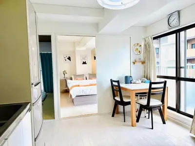 a room with a table and chairs and a bedroom at Ikebukuro\u4e2d\u5ddd6H-TS0037 in Tokyo