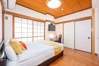 a bedroom with a bed and a sliding glass door at My Sumida Home B in Tokyo