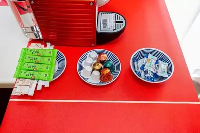 a toy kitchen with two plates of food on a red table at My Sumida Home B in Tokyo