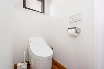 a bathroom with a toilet and a roll of toilet paper at My Sumida Home B in Tokyo