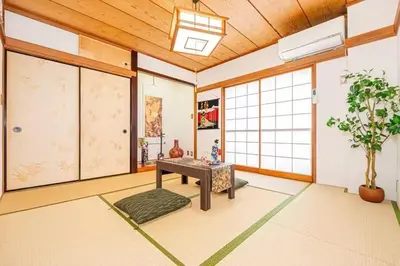 a living room with a table and windows at My Sumida Home B in Tokyo