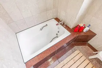a white bath tub in a bathroom with at My Sumida Home B in Tokyo