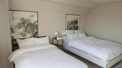 two beds sitting next to each other in a bedroom at Sakura house in Tokyo
