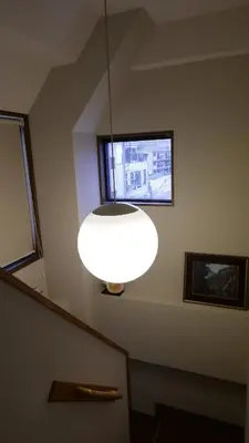 a large white light hanging from a ceiling at Sakura house in Tokyo