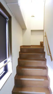 a staircase in a room with a window at Sakura house in Tokyo