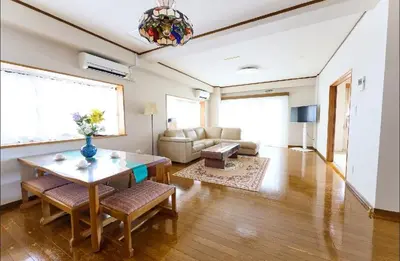a living room with a table and a couch at Sakura house in Tokyo