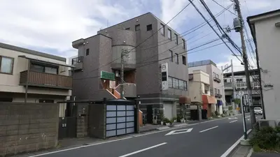 a building on the side of a city street at Sakura house in Tokyo