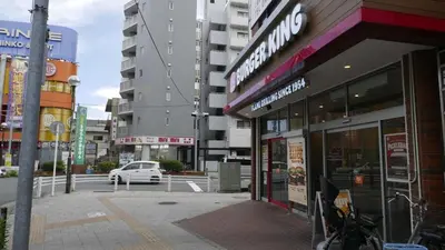a city street with buildings and a parking lot at Sakura house in Tokyo