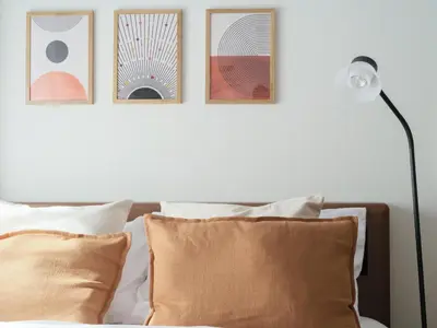 a bedroom with three pictures on the wall above a bed at m2\u30db\u30c6\u30eb in Tokyo