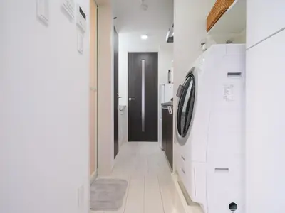 a white laundry room with a washer and dryer at m2\u30db\u30c6\u30eb in Tokyo