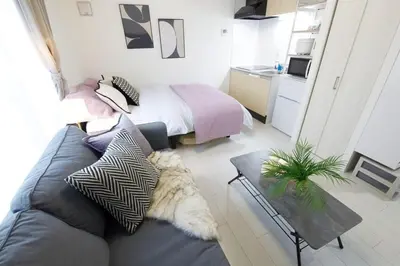 a living room with a couch and a bed at \u6e0b\u8c37\u533a\u4ee3\u3005\u6728302 in Tokyo