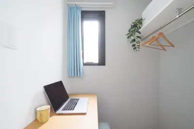 a laptop on a desk in a room with a window at Monzen-nakacho 1LDK with projector, 2 double beds,301 in Tokyo