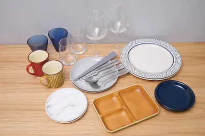 a table with plates and forks and wine glasses at Monzen-nakacho 1LDK with projector, 2 double beds,301 in Tokyo