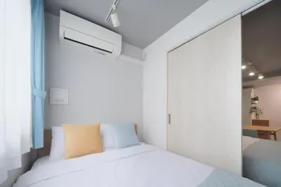 a bedroom with two beds and a window at Monzen-nakacho 1LDK with projector, 2 double beds,301 in Tokyo