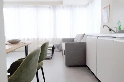 a kitchen and living room with a couch and a table at \u5922\u306e\u820e\u4e0a\u5317\u6ca2 Yumenoya Kamikitazawa in Tokyo