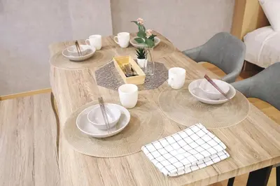 a wooden table with plates and utensils on it at \u5922\u306e\u820e\u4e0a\u5317\u6ca2 Yumenoya Kamikitazawa in Tokyo