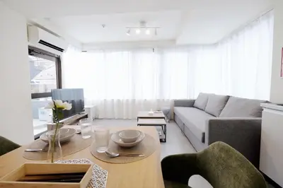 a living room with a couch and a table at \u5922\u306e\u820e\u4e0a\u5317\u6ca2 Yumenoya Kamikitazawa in Tokyo