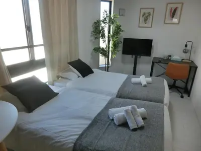 a bedroom with two beds with towels on them at \u6e0b\u8c37\u533a\u4ee3\u3005\u6728401 in Tokyo