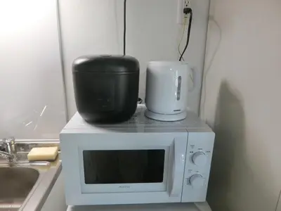 a microwave oven with a appliance on top of it at \u6e0b\u8c37\u533a\u4ee3\u3005\u6728401 in Tokyo