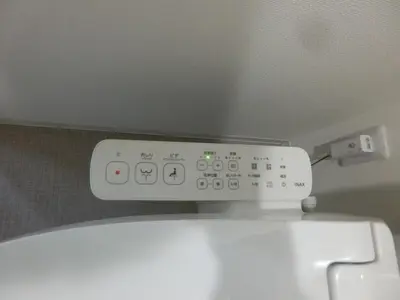a white toilet with a remote control on top of it at \u6e0b\u8c37\u533a\u4ee3\u3005\u6728401 in Tokyo