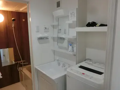 a white bathroom with a sink and a washer at \u6e0b\u8c37\u533a\u4ee3\u3005\u6728401 in Tokyo
