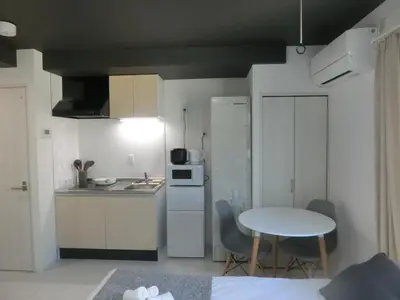 a room with a kitchen and a table and a small kitchen at \u6e0b\u8c37\u533a\u4ee3\u3005\u6728401 in Tokyo